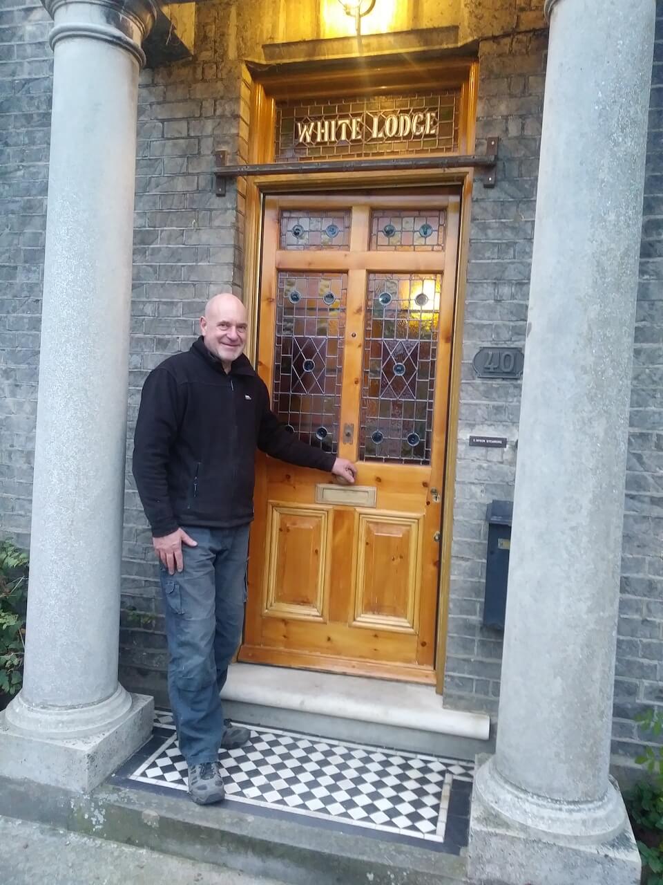 Barry with a newly installed stained glass doorframe